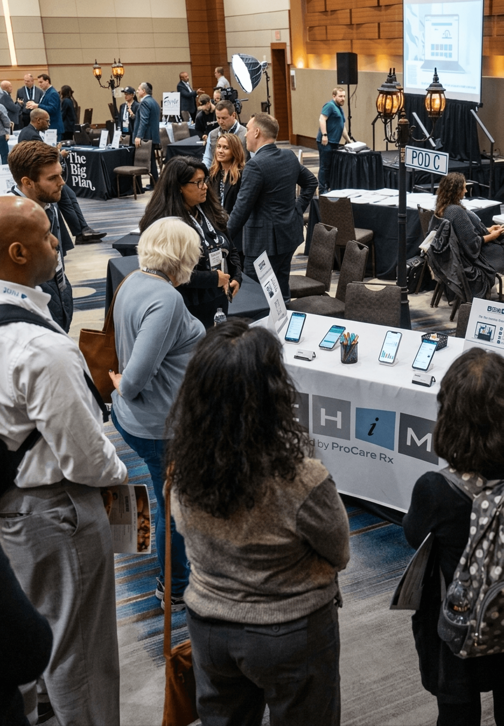 Advisers networking around six-table pods in the ASCEND open-architecture exhibit hall